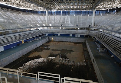 The Aquatic Stadium pool sits drained and abandoned.