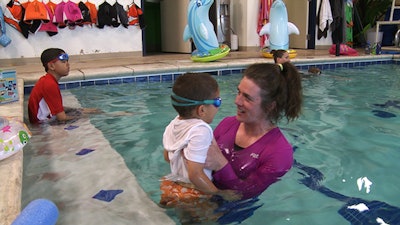 Angels of America's Fallen, one of the recipients of the Step Into Swim campaign grants, gives a swim lesson.