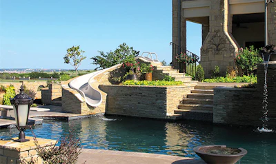 Visually integrating slides into the landscape can be a steep challenge, report some builders, but a modern system that supports an endless range of configurations makes the job far easier.