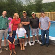 Leah's family pose with pool builders Cory Eagles and Brad Cross