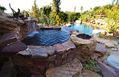 The colors and textures of the American Southwest are reflected in this suburban backyard oasis where natural and artificial stone structures echo the rugged desert topography.