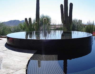 The perfect geometric lines of this spillover spa are accentuated by the random perfection of the surrounding desert landscape, a popular and powerful design strategy.