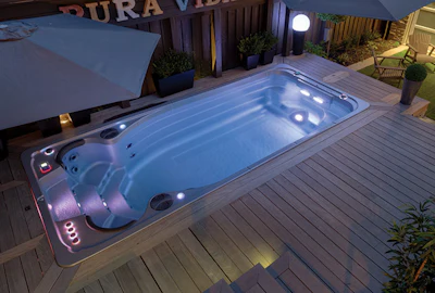 This swim spa from Hydropool fits beautifully into this backyard design, providing multiple aquatic activities in a limited space.