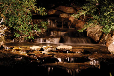 Moving water provides unique opportunities to create interest and character in the outdoor space after the sun goes down.