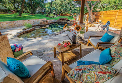 The pool area and surrounding landscape are an expression of the clients' creative personalities and active lifestyle. According to Loy, the scene is constantly evolving with naturalistic landscape features and artistic furnishings, along with a steady supply of home-brewed beer.