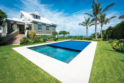 This project in Bermuda installed by Pool Patrol is a classic example of beautiful custom rectangular pool fitted with an automatic cover system.