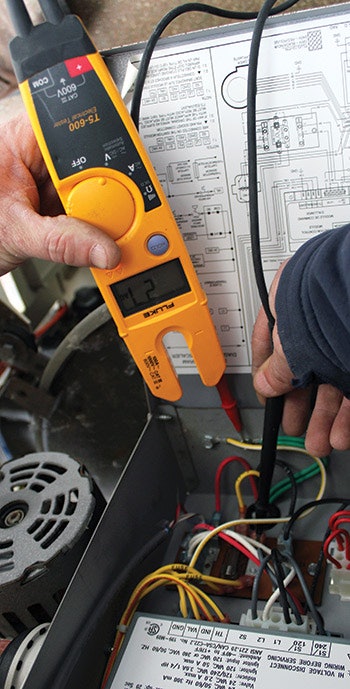 Checking connections with a T5-600 Electrical Tester.
