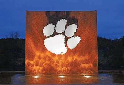 The new fountain at Clemson University uses shimmering glass tile and a white marble tiger paw to celebrate the school’s pride and community spirit.