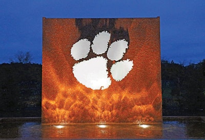 The new fountain at Clemson University uses shimmering glass tile and a white marble tiger paw to celebrate the school’s pride and community spirit.