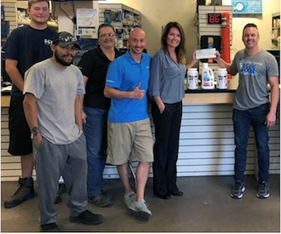 Matthew Barclay of Blue Moose Pools receives the prize money at his SCP branch in Phoenix, Ariz.