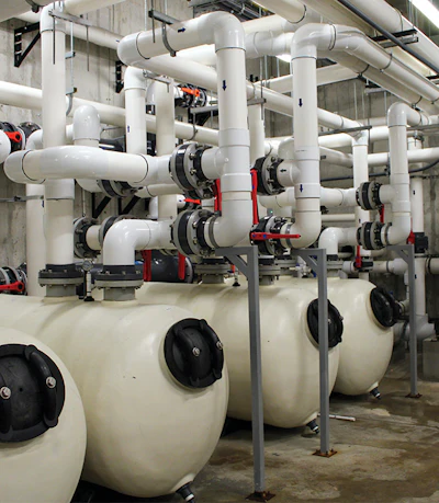 Four of the lagoon's eight TH model horizontal sand filters, manufactured by Pentair. On the end of each unit is a black hatch that can be removed for physical access and cleaning. On startup, the massive amounts of debris in the pool clogged the filters, and had to be cleared repeatedly. 'The water in there looked like chocolate,' says Alvarez.