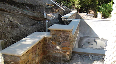 The area behind this project's retaining wall has been over excavated and the initial waterproofing has been applied.