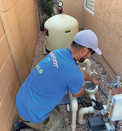 Garcia swaps out a pump in a tight space.