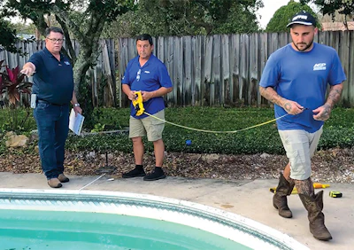 Measurement across the pool to a fixed point A. Minton marks points along the pool with chalk or masking tape.