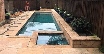 Previously, the water features of this pool caused too much of an echoing effect in such a small backyard. The water features were canceled in the renovation. (Photo courtesy Bowen Pools, Nick Allen Photography)