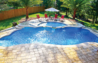 Ample and handsomely executed outdoor living space turns this fiberglass pool backyard into something both visually alluring and functional.