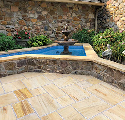 The pool renovation shown at the top of page 28 influenced the design of this client's water fountain. Builders suggest blending design elements with the home's surrounding landscape. (Photo courtesy Kevin Barry)