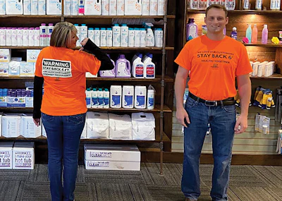 Friendly t-shirts remind customers that keeping 6-feet of distance is still the preferred protocol.