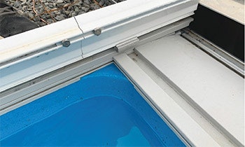 Installing the track in the corners of a fiberglass pool can present a challenge.