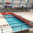 The 'Swim Gym' court retracting underneath the arena's bleachers. (Courtesy Pacific Floor)