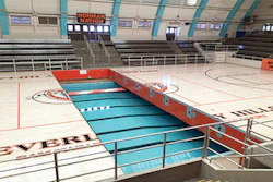 The 'Swim Gym' court retracting underneath the arena's bleachers. (Courtesy Pacific Floor)