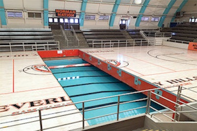 The 'Swim Gym' court retracting underneath the arena's bleachers. (Courtesy Pacific Floor)