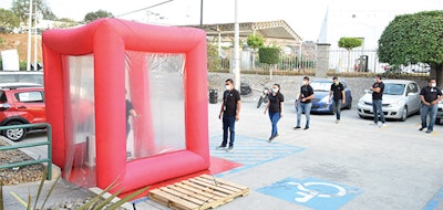 An inflatable disinfection tunnel stationed outside the Core Covers manufacturing facility sprayed 600 employees daily with alcohol-based disinfectant, allowing the plant to continue producing in the pandemic.