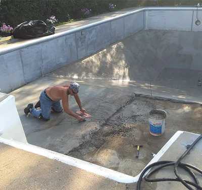 It takes some skill to get a great finish with no trowel marks. In this case, an employee of All Seasons Pools smooths out a pool floor using Pool Krete.