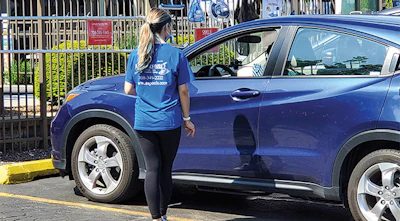 Pandemic conditions forced retailers to restructure their systems for providing products and services, leading to permanent changes in the industry. Here, an employee of All Seasons meets a customer at a designated parking spot to deliver products. (Photo courtesy All Seasons)