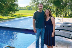 Pat and Sarah Barrett stand in front of their automatic pool cover that saved the life of a woman who safely drove over it after losing control of her car. (Photos courtesy Brad Lovins)