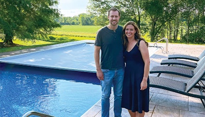 Pat and Sarah Barrett stand in front of their automatic pool cover that saved the life of a woman who safely drove over it after losing control of her car. (Photos courtesy Brad Lovins)