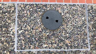 This aggregate surface was approximately 25 to 30 years old when we replaced the skimmer. Finding aggregate to match all those years later was no small order, but we managed to come close using a custom blend. This picture was taken about a year after the skimmer was replaced and is an example of why we use mastic seal expansion joints in projects where I anticipate the deck will move. Looking closely at the mastic you can see how it has been impinged by the deck movement.