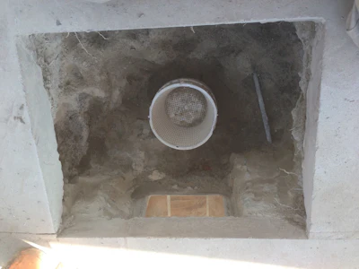 We've cut the deck and made our way down through the gunite, which has been removed to locate the plumbing lines. Here, about 70 percent of the material has been removed.