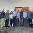 The photo features (from left to right): Steve Barnes, Mike Kraemer, Chet Williams, Mandy Snow, Olaf Mjelde, Todd Pieri, Devin Cahn, Morgan Cahn, Scott Wallace, and Teresa Franciscovich.