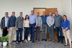 The photo features (from left to right): Steve Barnes, Mike Kraemer, Chet Williams, Mandy Snow, Olaf Mjelde, Todd Pieri, Devin Cahn, Morgan Cahn, Scott Wallace, and Teresa Franciscovich.