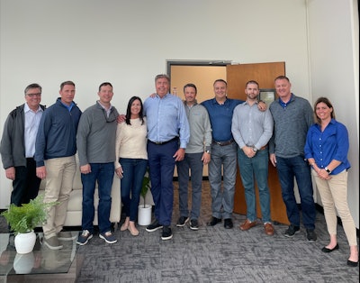 The photo features (from left to right): Steve Barnes, Mike Kraemer, Chet Williams, Mandy Snow, Olaf Mjelde, Todd Pieri, Devin Cahn, Morgan Cahn, Scott Wallace, and Teresa Franciscovich.