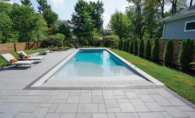 Equipment access and egress in tight backyards like this always calls for careful planning. Shown here is a beach entry pool from Thursday Pools.
