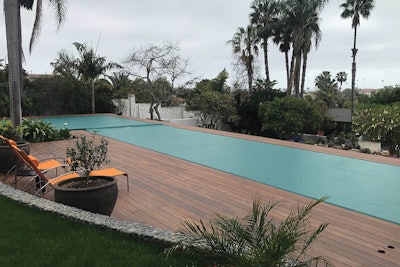 Perimeter overflow pool covered neatly by PoolSafe in San Marcos, Calif.