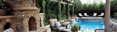 Hedges of Fern Pine and Caroline Cherry Laurel provide a lush evergreen backdrop and reduce the wind’s influence on the water surface.