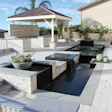 Water features like the rainfall on this contemporary pool project increase aeration and evaporation. They should be set to run during the times of day they will be most appreciated.