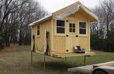 A portable, battery-operated jack system helps to bring the sauna off the trailer and safely on the ground.
