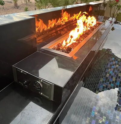 The black tile for the back fireplace wall is made of porcelain, which withstands high temperatures, and the fire feature is liquid petroleum gas with an electronic spark ignition and a gas-flow control key.
