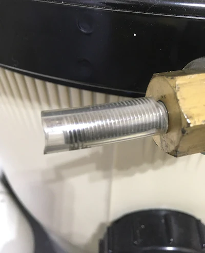 Put the filter tank clamp on with the bolt pointing away from work spaces. Put a piece of vinyl tubing on the bolt end to prevent snags or operator puncture hazard.