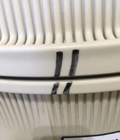 In this case, the tool is a sharpie, used to make handy reference marks on all kinds of things. Here, index marks on the tank top and bottom show where to line up when reassembling. The plastics have a memory, and it seals best if reassembled in the same place.