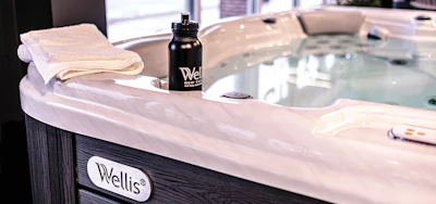 Details, such as a water bottle and neatly folded towel, make the showroom spas look more inviting.