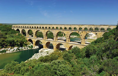 Roman aqueducts, like this one in France, were built using concrete, stone and brick. Water was propelled for many miles by gravity down a slope of about 1 foot per mile.