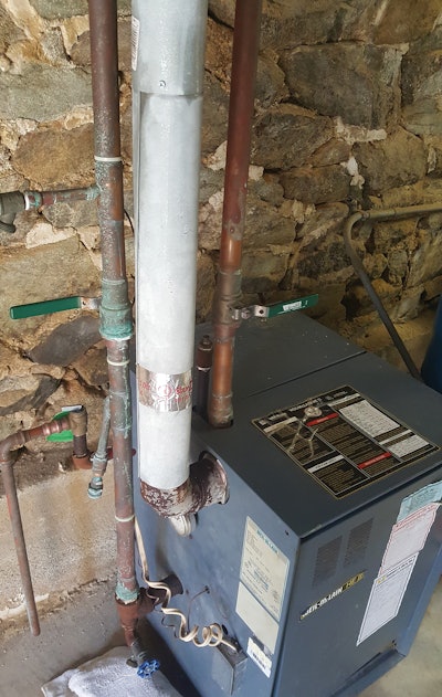 This is a Category 3 appliance that has been vented with incorrect material. Condensate became trapped in the vent elbow and caused deterioration.