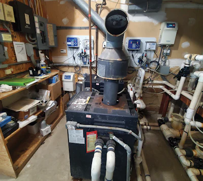 A non-functioning barometric damper, as seen here, is another opportunity for carbon monoxide to escape the flue and enter the occupied space.