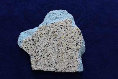 A sample of a blue pigmented plaster and pebble finish where the cement portion has lost the blue color and turned white. Note the absence of any calcium scale deposit over the pebble aggregates, which eliminates that cause of the plaster whitening effect.