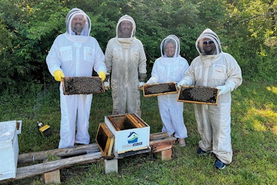 The team from Georgia Spa Company takes sweet donations from tiny local workers. The honey is bound for hungry and appreciative consumers in the area, and the profits go toward education on the importance of honey bees.